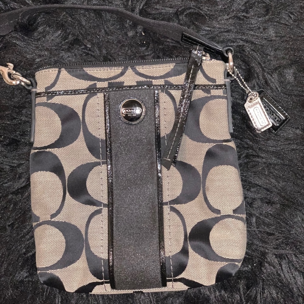 Older style small coach cross-body purse.